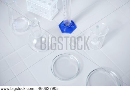 Top View Of Labware For Biochemical Experiment. Petri Dish, Flasks, Graduated Cylinder, Beaker, Stan
