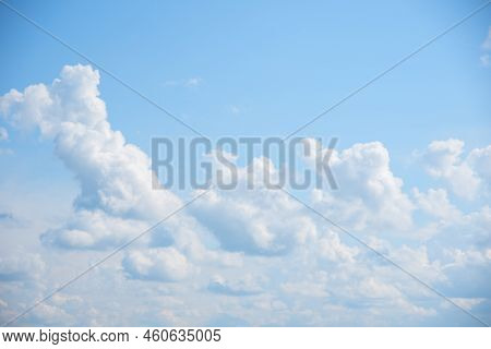 Blue Sky Background With White Fluffy Cumulus Clouds. Panorama Of White Fluffy Clouds In The Blue Sk