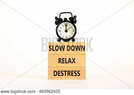 Destress Symbol. Concept Words Slow Down Relax Destress On Wooden Block. Black Alarm Clock. Beautifu