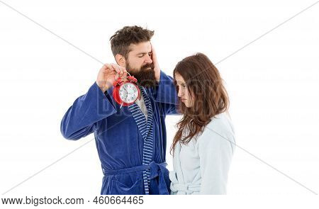 Waking Up By Alarm Clock Signal. Pretty Woman And Bearded Man Holding Alarm Clock Early In The Morni