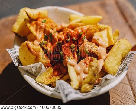 A Portion Of Spanish Patatas Bravas With Spicy Sauce
