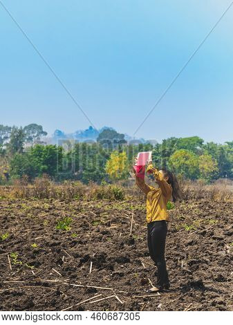 Female Farmer Use Tablet To Take Wide Angle Shots Of Land To Make Farming Decisions In Soil Field. W