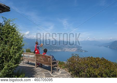 Stresa, Italy - August 17, 2018: Tourists In The Giardino Botanico Alpinia Park Overlooking Lake Mag
