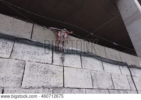 Brick Wall With A Piece Of Cloth Hanging On Its Wires