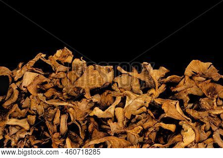 Dry Golden Chanterelles Or Girolle Mushrooms Isolated On A Black Background With Copy Space. Top Vie