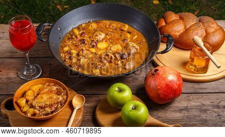 Festive Table For Rosh Hashanah Cholent, Pomegranate, Wine, Honey, Apples, Challah. Horizontal Photo