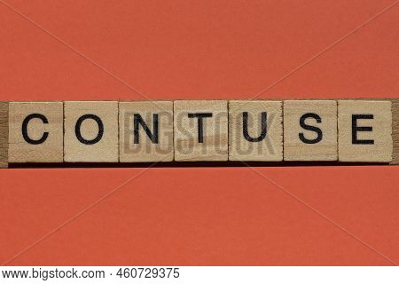 Word Contuse From Gray Wooden Small Letters With Black Font On An Orange Background