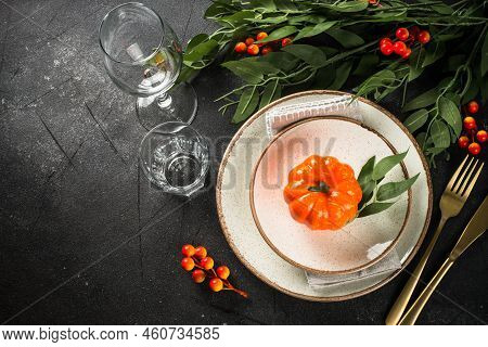 Autumn Table Setting With Plate, Cutlery, Pumpkin And Candles. Thanksgiving Food Festive Dinner Conc