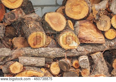 Natural Wooden Background - Close-up Of Chopped Firewood. Firewood Is Stacked And Prepared For Winte