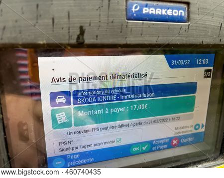 Strasbourg, France - Mar 31, 2022: Pov Male Hand Looking At Parkeon Parking Meters With Digital Disp