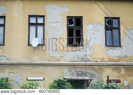 Derelict House With Two Broken And One Normal Window