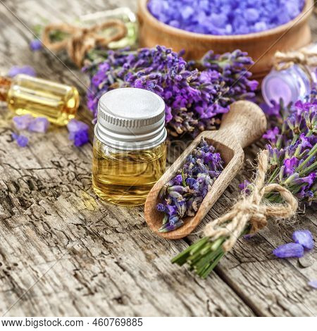 Lavender's Spa Products With Dried Lavender Flowers On A Wooden Table. Flat Lay Bath Salt And Massag