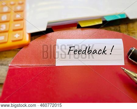 Feedback Text Written On Paper With Red Envelope Background. Rating Review Concept. Stock Photo.