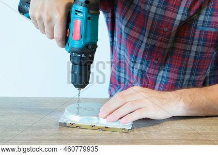 Drilling A Hard Disk Drive To Destroy Evidence Data Close Up. Concept Of Deleting Big Data By Drilli