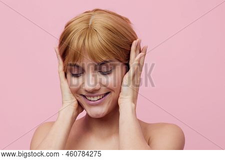 A Close Horizontal Photo Of A Pleasant, Lovely Woman With Perfect Skin, Standing On A Pink Backgroun