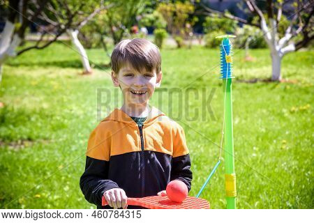 Happy Boy Is Playing Tetherball Swing Ball Game In Summer Campin