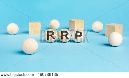 Concept Text 'rrp' On Wooden Spheras On A Beautiful Blue Background. Business Concept. Copy Space. R
