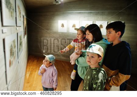 Mother With Children Exploring Expositions In Museum Halls.