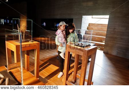 Mother With Children Exploring Expositions In Museum Halls.