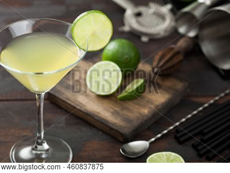 Gimlet Kamikaze Cocktail In Martini Glass With Lime Slice And Ice On Wooden Background With Fresh Li