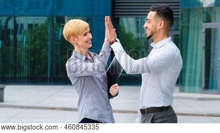 Multi-ethnic Co-workers Caucasian Woman And Hispanic Man Stand Outdoors Company Building Make High F