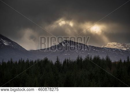 Landscape Image Of Dramatic Winter Storm Sunset Clouds Over The Peaks Of Beinn Toaig And Stob A'choi