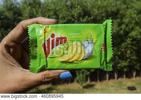 Female Holding Utensil Dishwash Soap Vim Bar Lemon. Lemon Vim Bar Soap Dish Washing Packet Of Rs. 5 