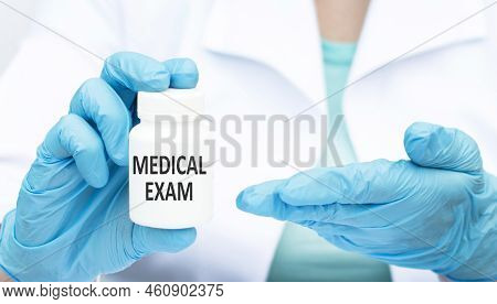 The Doctor Holds A Jar Of Medicine Points With His Second Hand At The Label With The Text Medical Ex