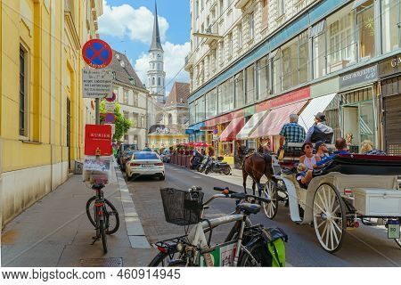 Narrow Street Of European City With Multi-colored Facades Of Houses, Bicycle And Car Parking, Road S