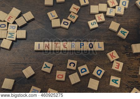 Top View Of Colorful Square Wooden Letters Creating The Word Interpol. The International Criminal Po