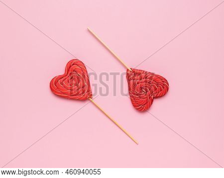 Two Red Heart-shaped Candies On A Pink Background. Minimal Concept Of Sweet Life And Love. Flat Lay.