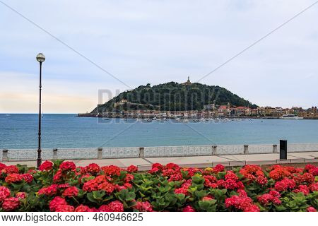 View Of La Concha Bay And Mount Urgull, San Sebastian Donostia At Sunset With The City Coastline And