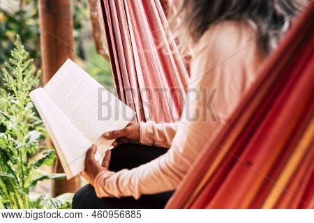 Reading A Paper Book Old Style Concept To Relax And Study - Aged Caucsian Woman With White Hair Sitt