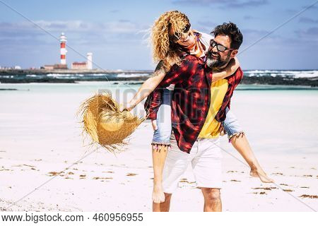 Cheerful People Happy Joyful Couple Playing Together In Love With Man Carrying Woman Laughing A Lot 