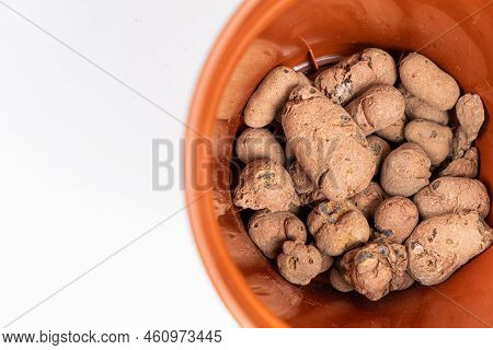 Claydite Drainage Stones In A Pot For Houseplants On A White Background.