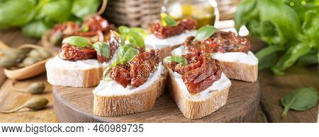 Bruschetta With Sun-dried Tomatoes, Cheese, Basil And Capers. Traditional Appetizer For Aperitivo In