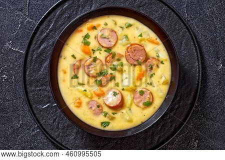 Kartoffelsuppe, German Potato Soup With Sausages In Black Bowl On Dark  Concrete Table, Horizontal V