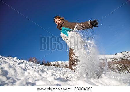 Snowboarder jumping through air with deep blue sky in background