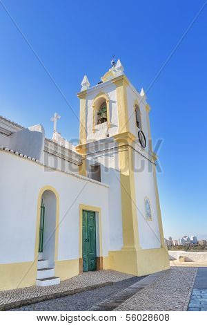 Old Church In The Village Of Ferragudo. View Of The Bell And Cross Religious.