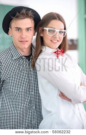 Smiling classmates posing together in schoolroom