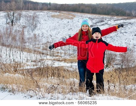Happy children together outdoors in winter.