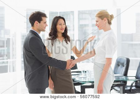 Businesswoman introducing colleagues in the office