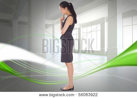 Thoughtful businesswoman against abstract white and green line design in room