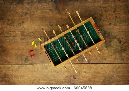 Mini soccer game on an old wooden table. Tactics, game planning concept.