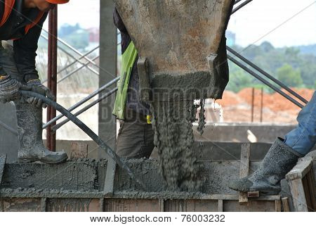 Group of construction workers casting beam