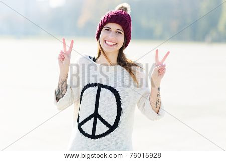 Young woman making peace sign 