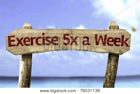 Exercise 5x a Week sign with a beach on background