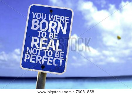 You Were Born To Be Real Not To Be Perfect sign with a beach on background
