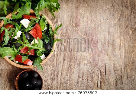 Greek Salad In A Wooden Salad Bowl On The Table