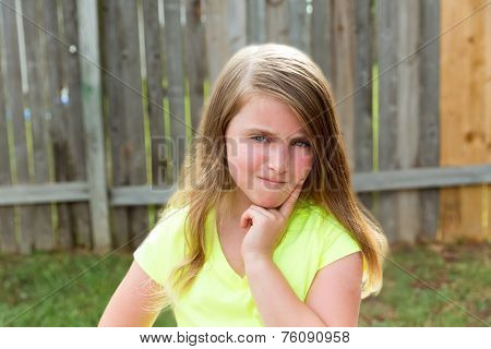 kid girl with disappoint expression finger thinking expression outdoor